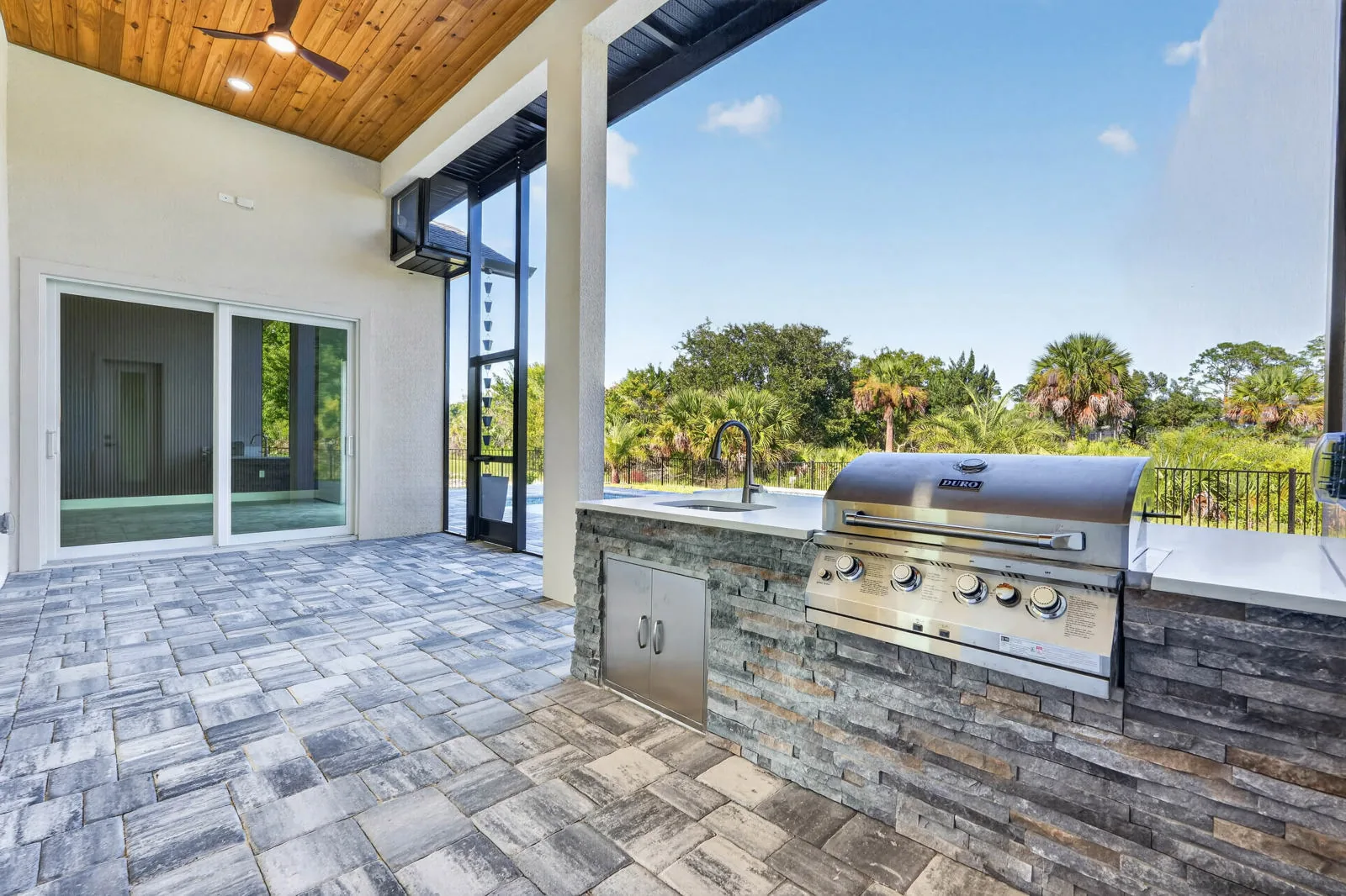 The Anna Marie model by Wise Choice Custom Homes, covered outdoor kitchen with mahogany ceiling