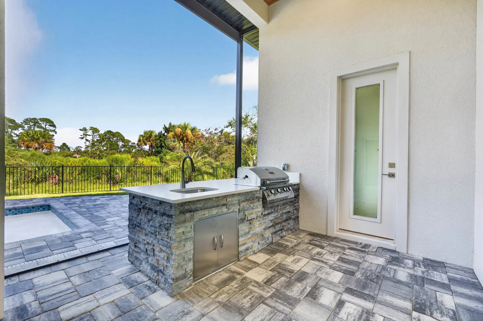 The Anna Marie model by Wise Choice Custom Homes, covered outdoor kitchen with mahogany ceiling